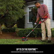 Photo of person using Craftsman string trimmer CMCST920M1 outdoors, trimming grass near a house with garden bushes.